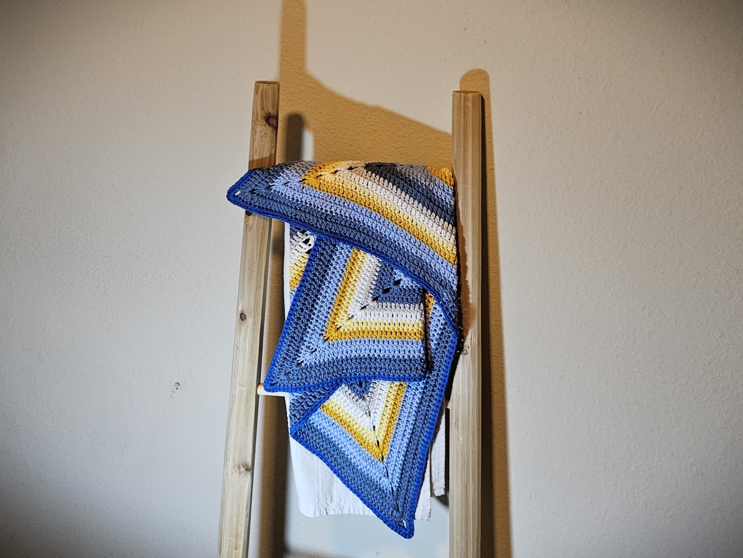 Star Baby Blanket folded on a wooden ladder